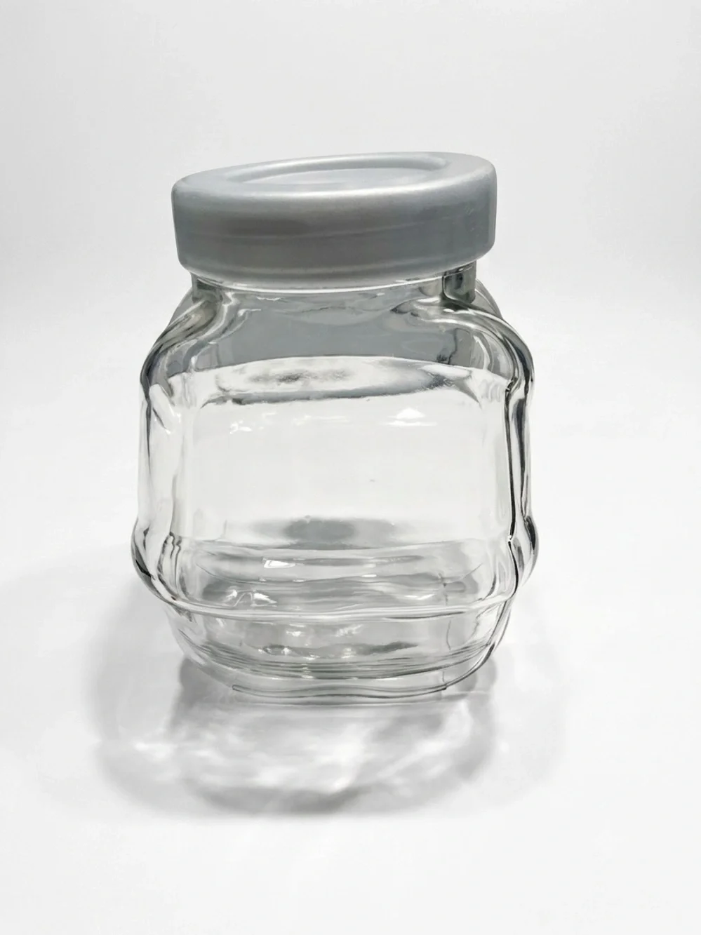Ikea Förvar glass canister featuring a distinctive hexagonal shape & a gray lid.